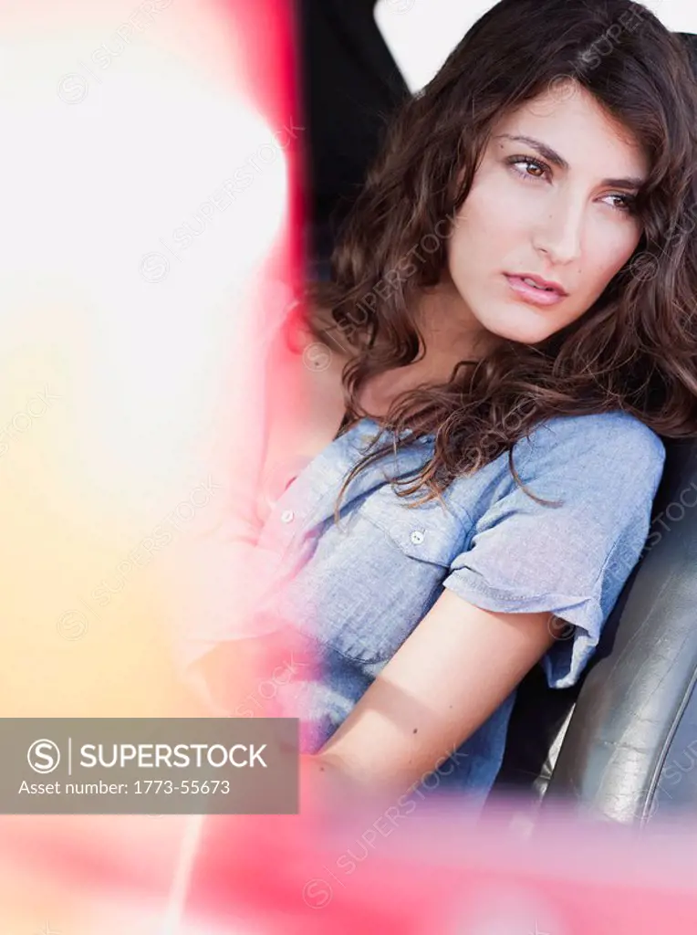 woman sitting in front seat of car