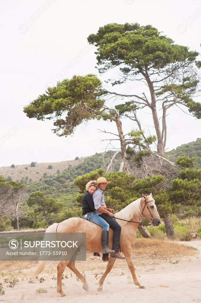 woman and man riding together on a horse
