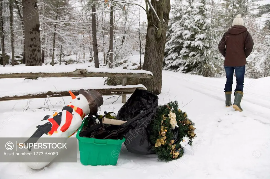 Woman disposing of festive decorations