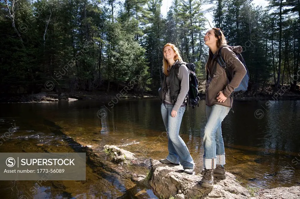 Two women hiking beside lake