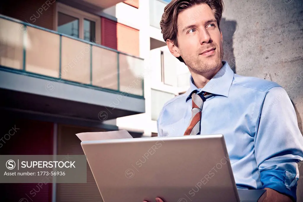Businessman with laptop on site