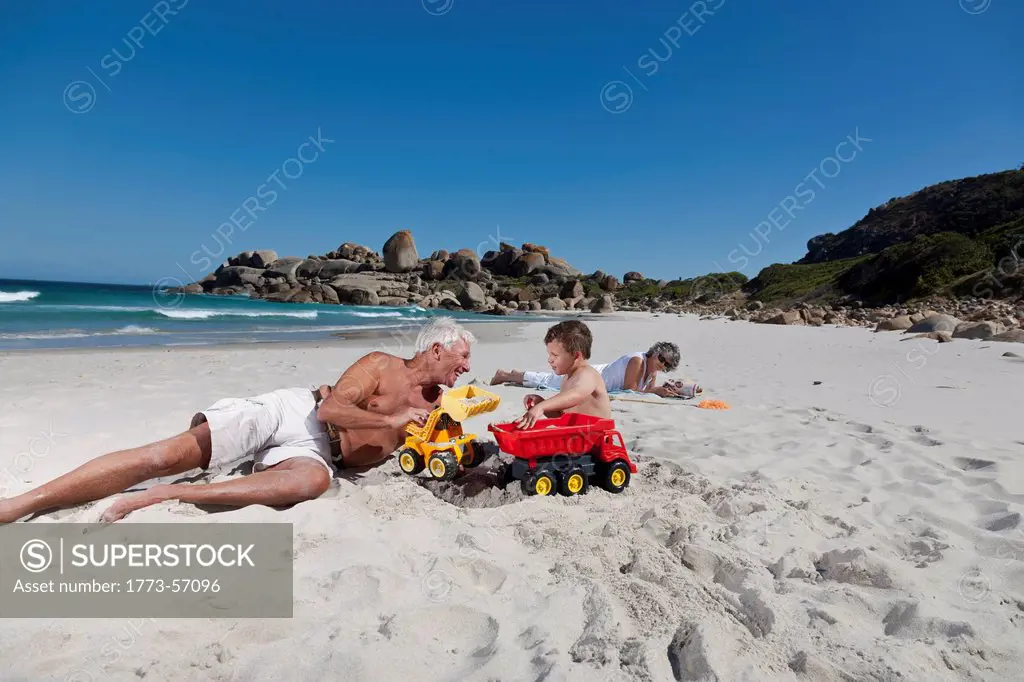 Man playing with grandson on beach
