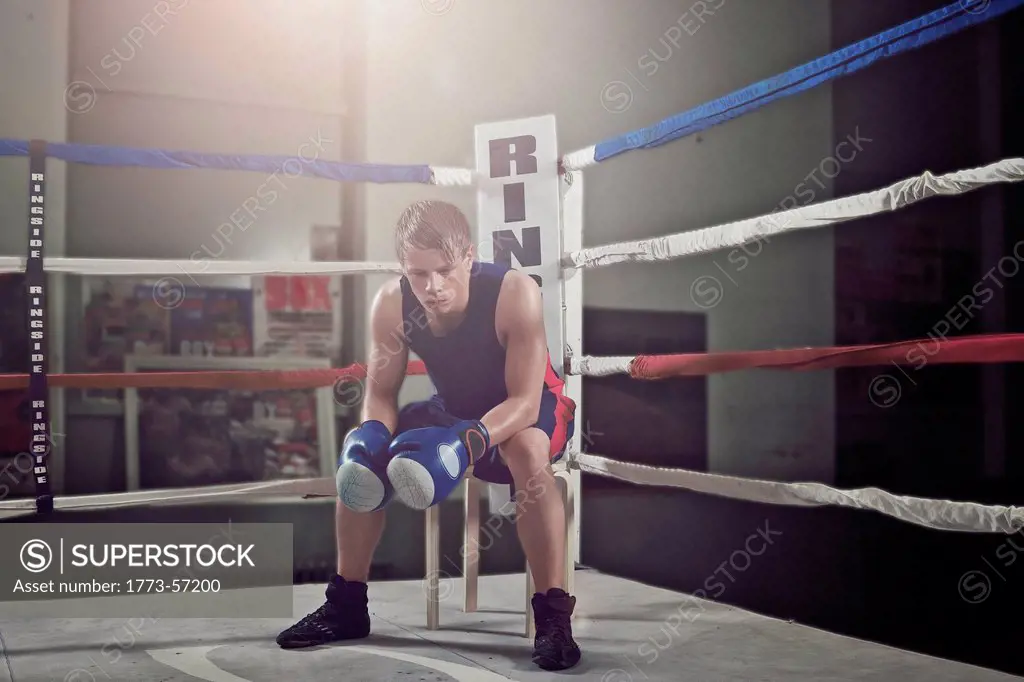 Boxer sitting in corner of ring