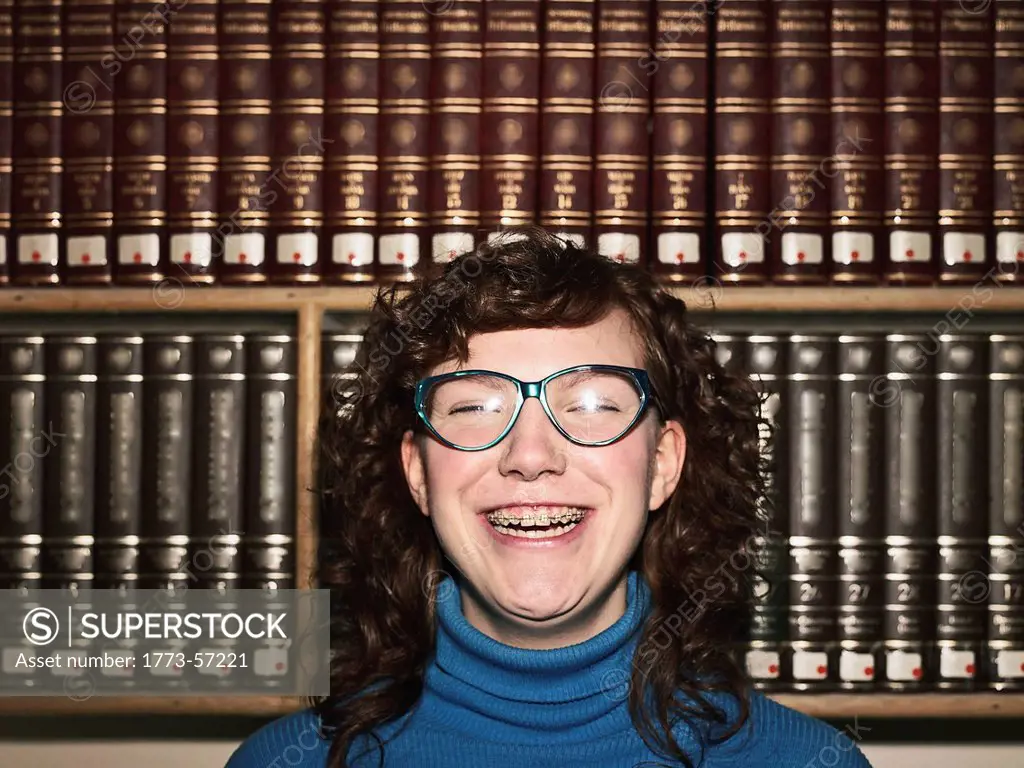 Woman with glasses and braces in library