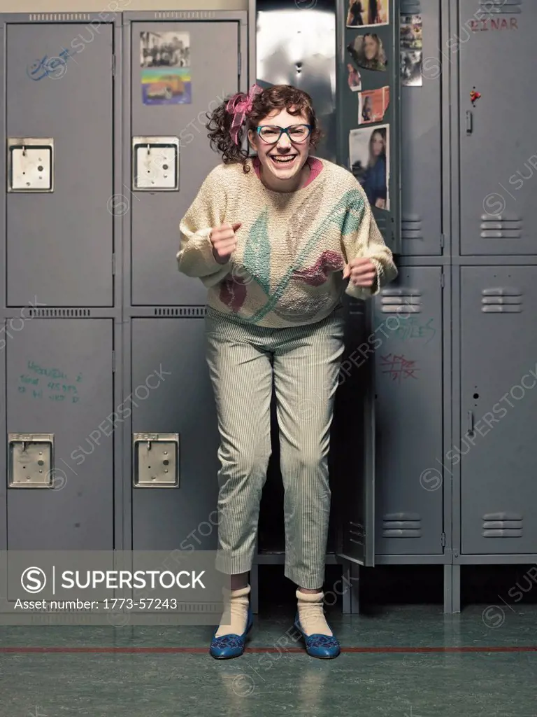 Woman in glasses dancing at her locker