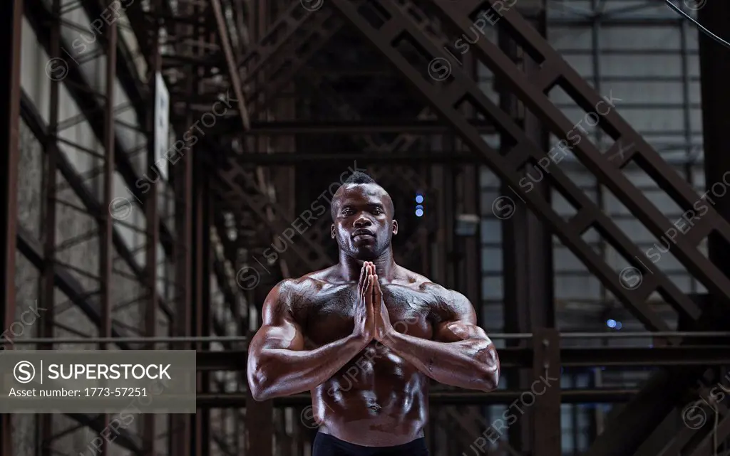 Bare_chested athlete in prayer position