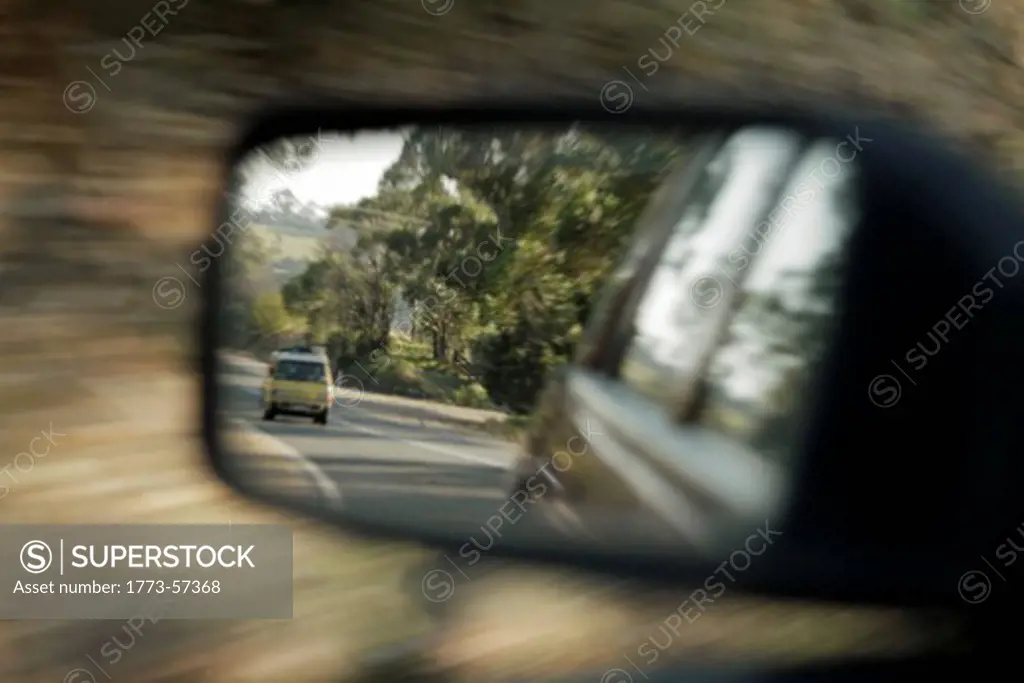 Blurred view of car in side mirror