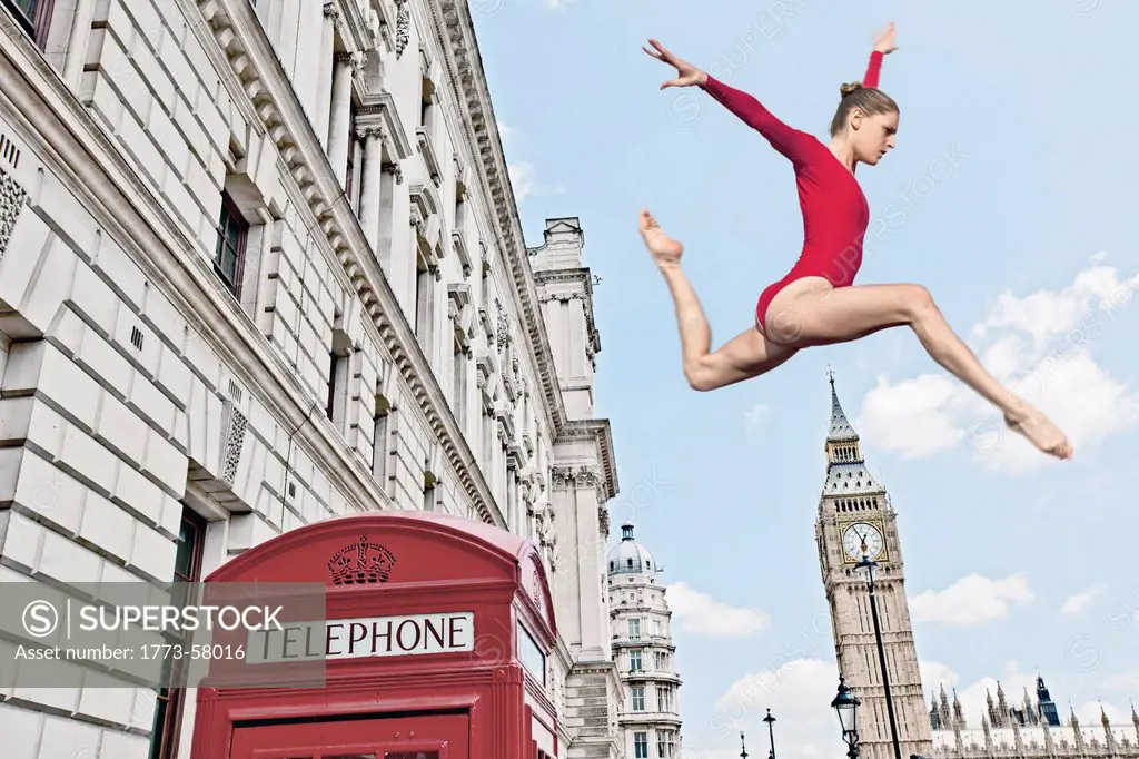 Gymnast leaping from telephone booth