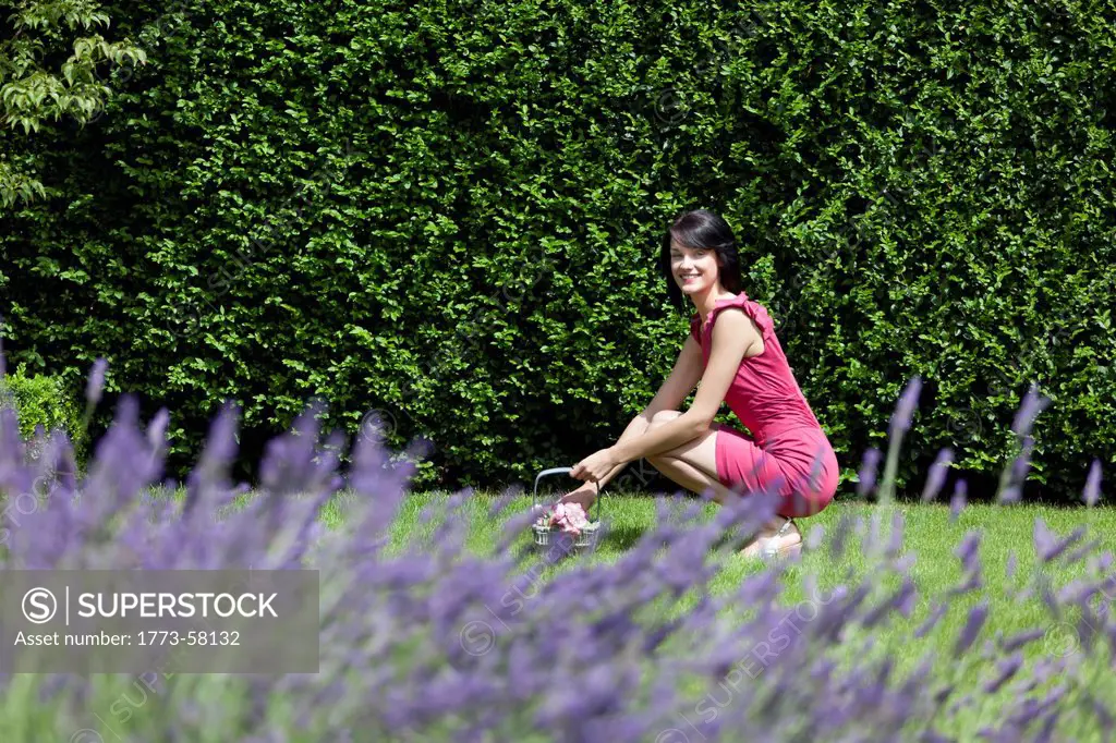 Woman gathering flowers outdoors