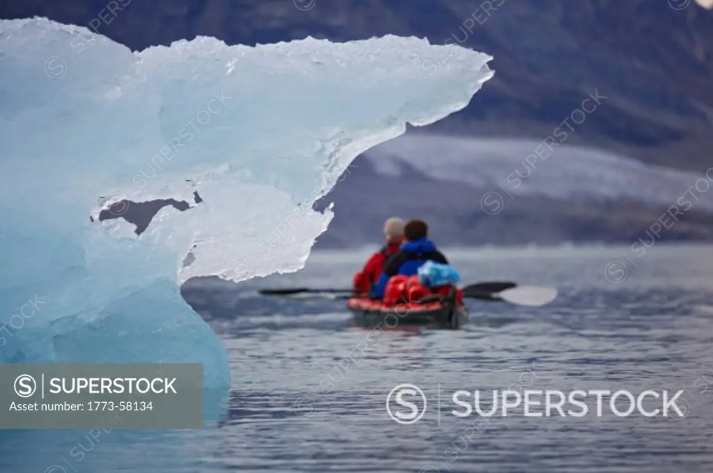 People kayaking near glaciers