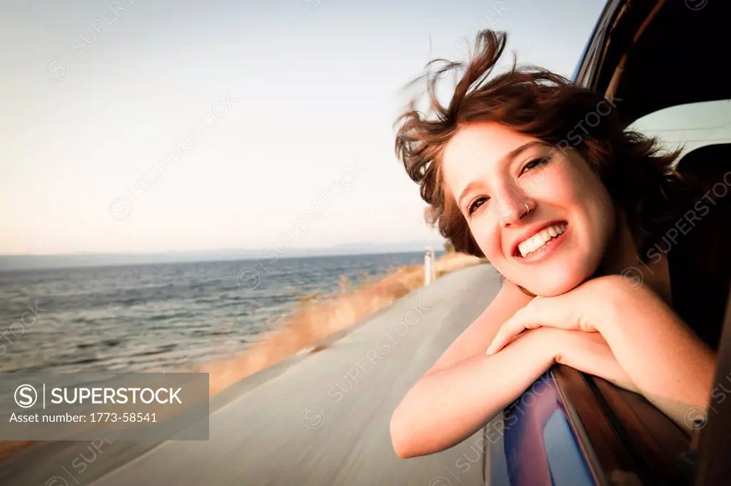 Woman smiling out of car window