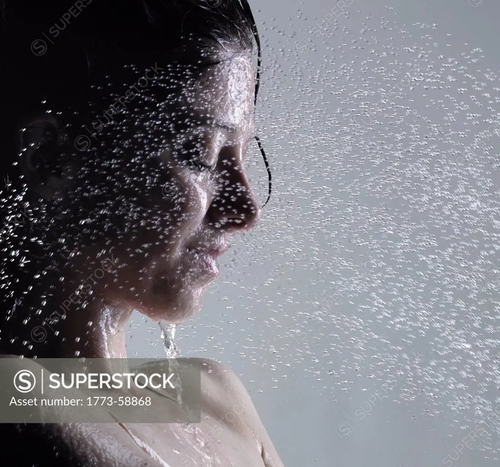 Woman washing her face in shower