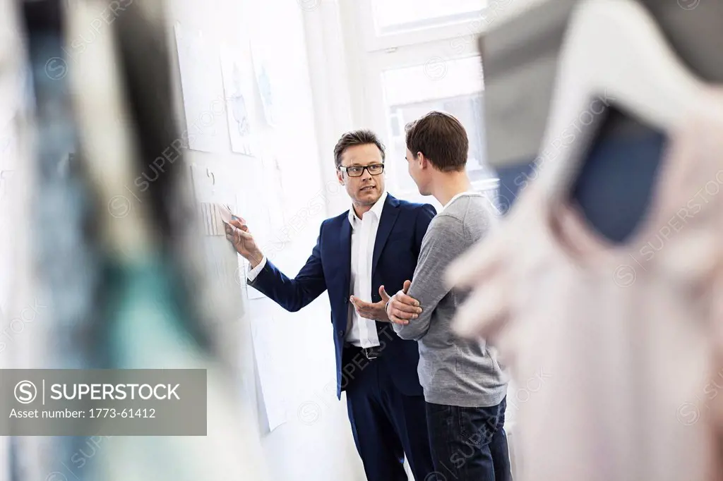 Businessman taking pictures in office