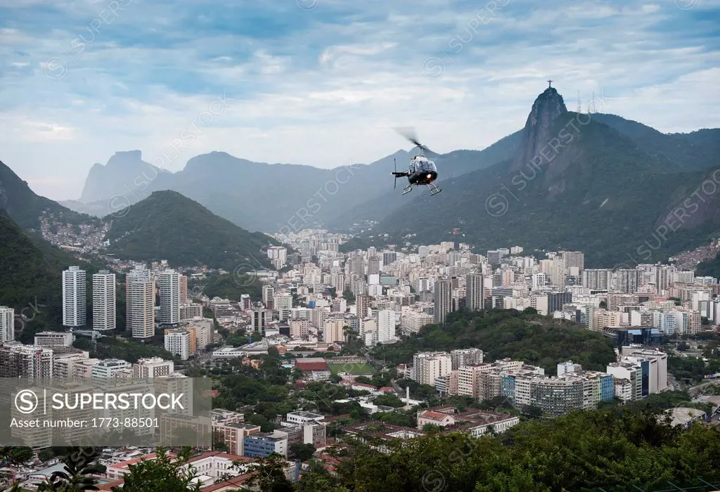 Helicopter above the city of Rio de Janeiro. Behind, very small the statue Christ the Redeemer Cristo Redentor