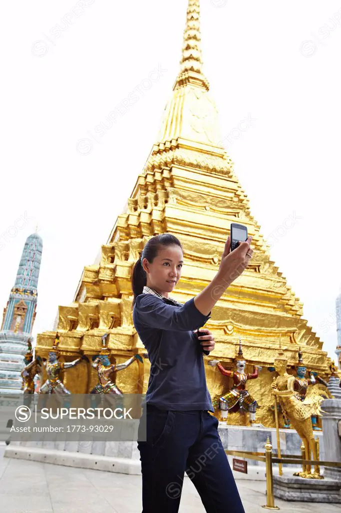 Woman taking pictures at ornate temple