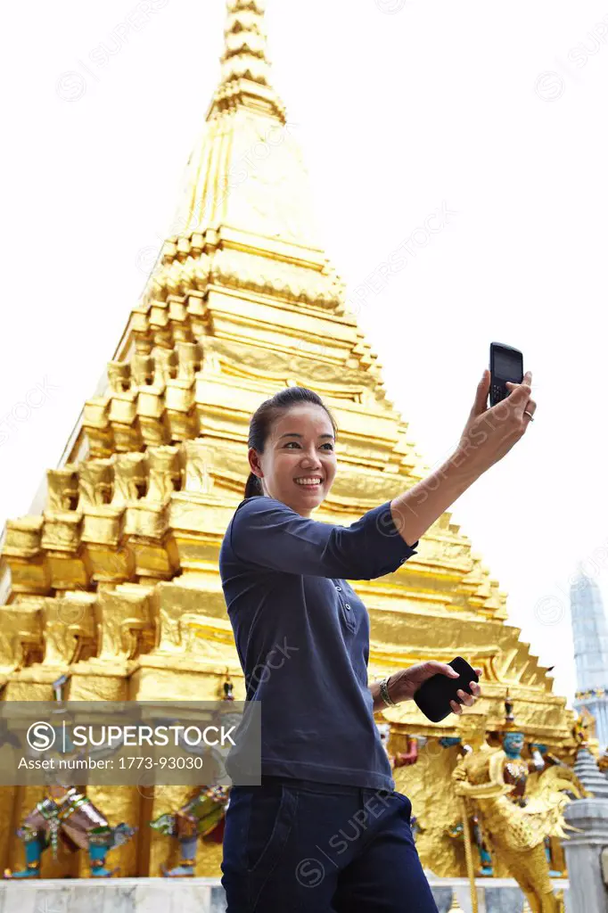 Woman taking pictures at ornate temple