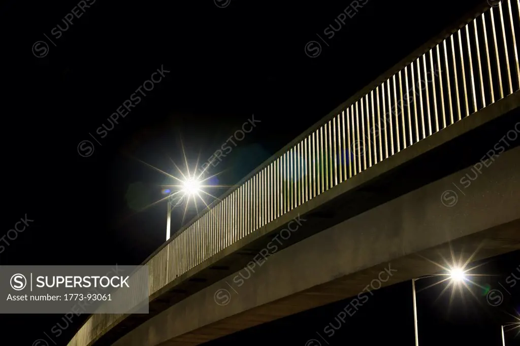 Streetlights on urban bridge