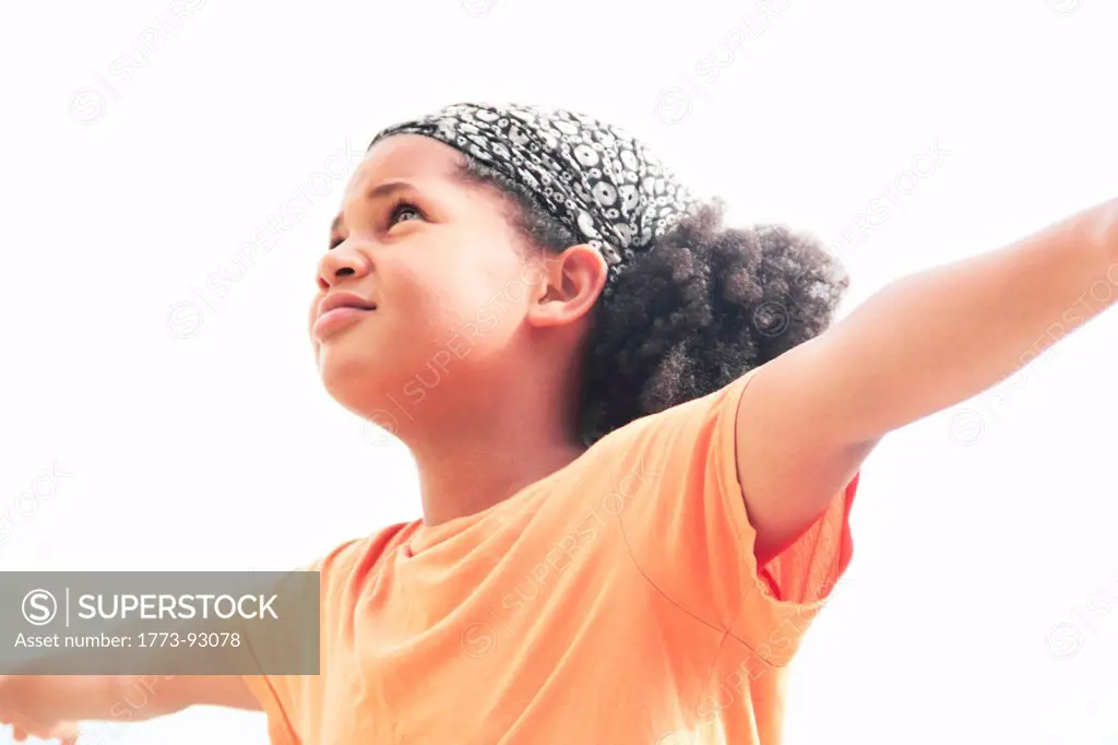 Girl standing with arms outstretched