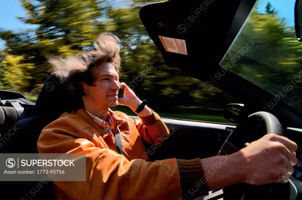 Man driving and talking on cell phone