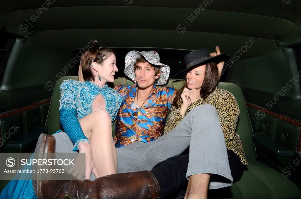 Man sitting with women in limousine