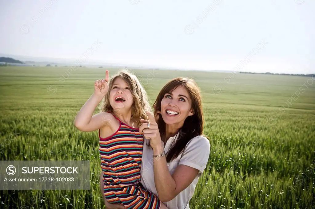Woman and child pointing at sky