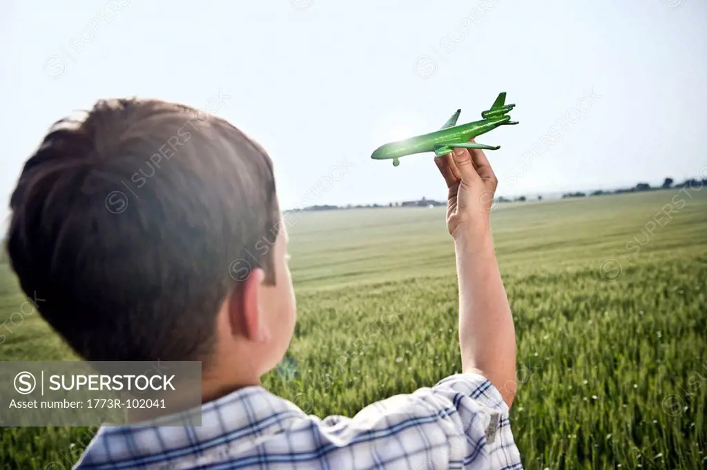 Boy playing with toy plane