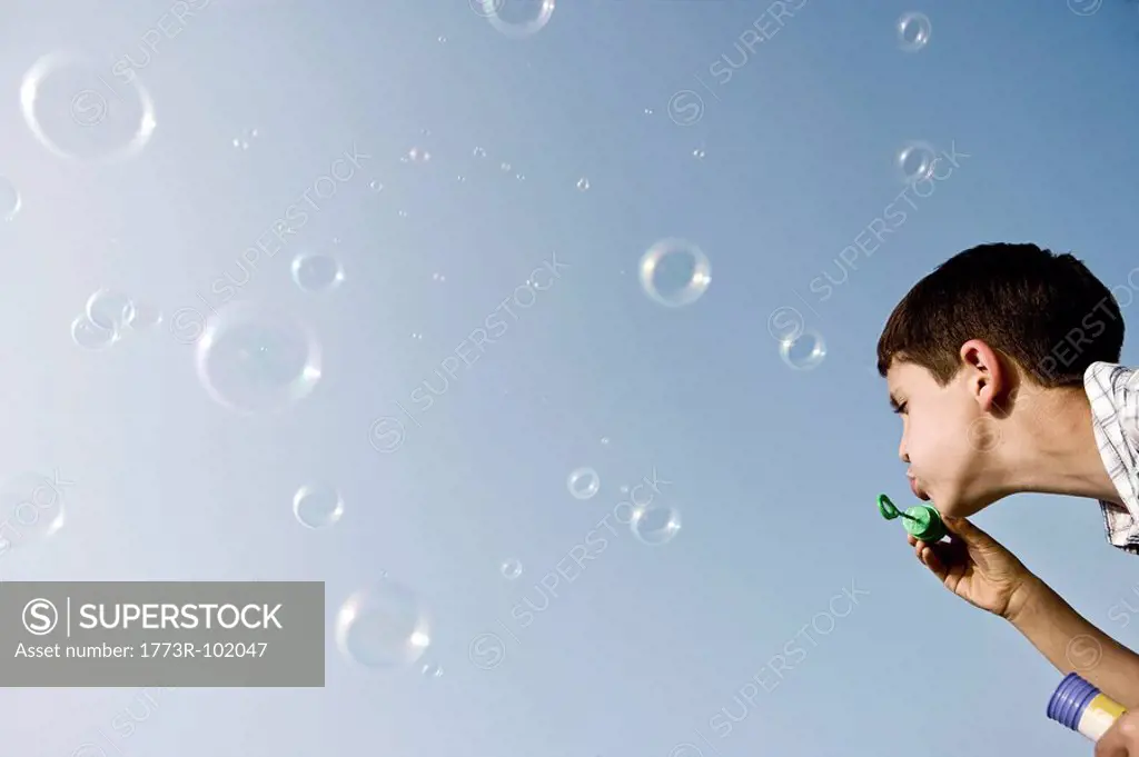 Boy blowing bubbles