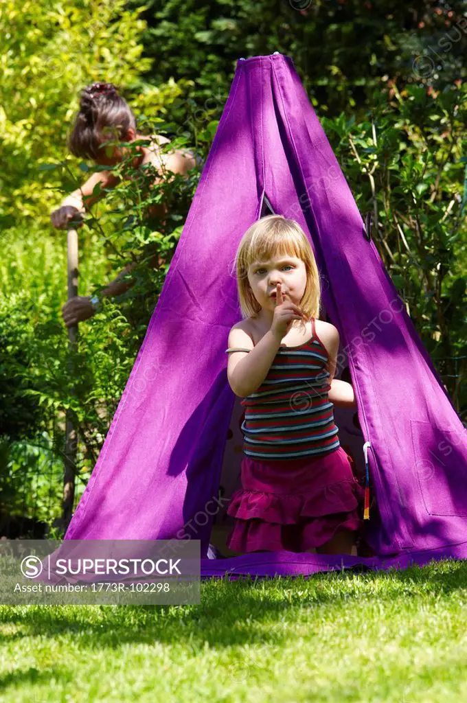 Girl in a teepee, shot from outside