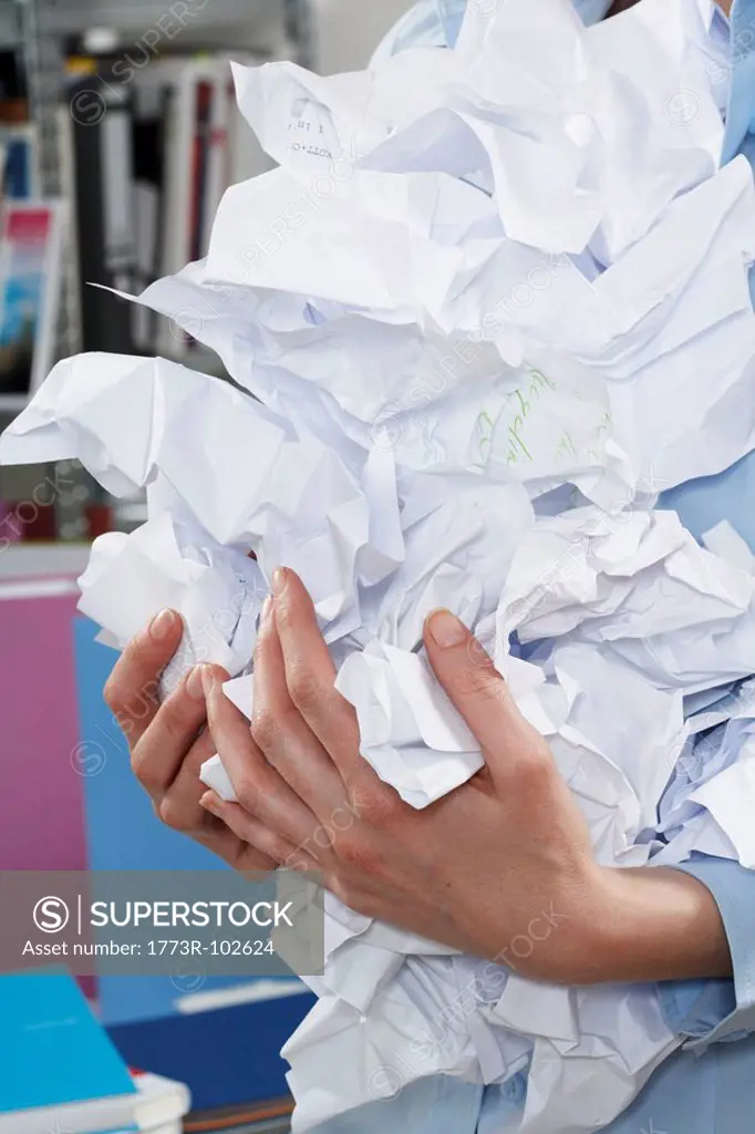 Businesswoman holding crumpled paper