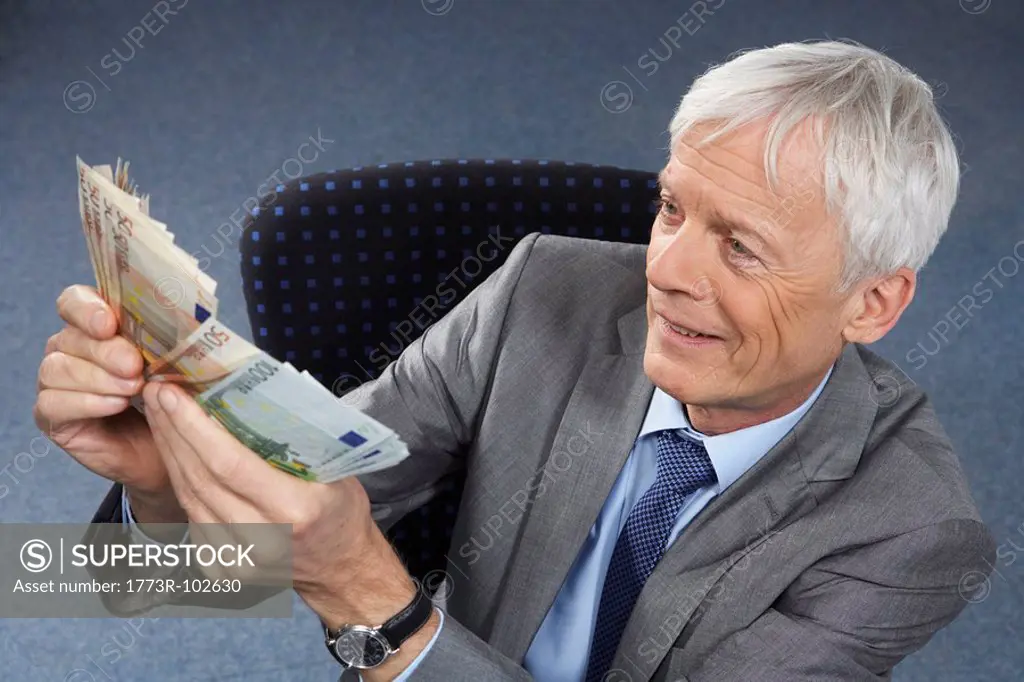 Businessman with lots of money in hands