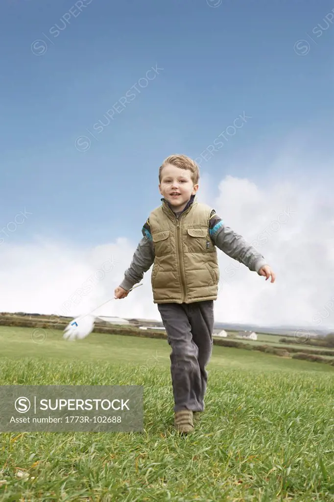 Boy running with windmill