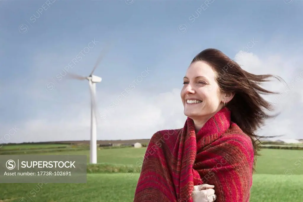 Woman with hair blowing on a wind farm