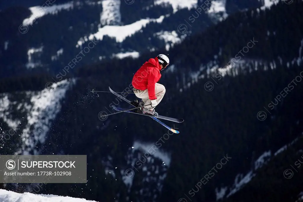 Skier jumping trees in the background