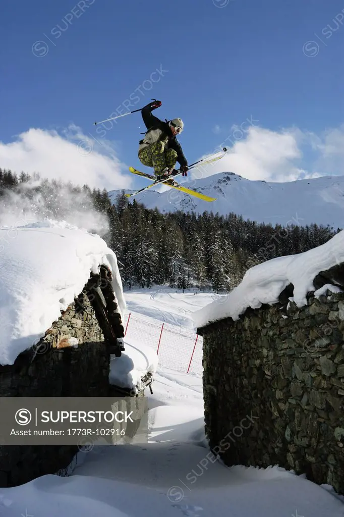 Skier jumping over buildings