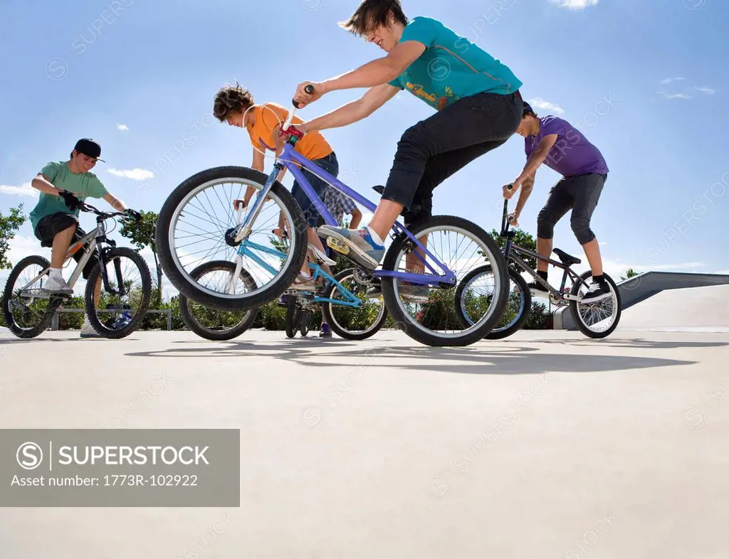 Teen boys riding bikes