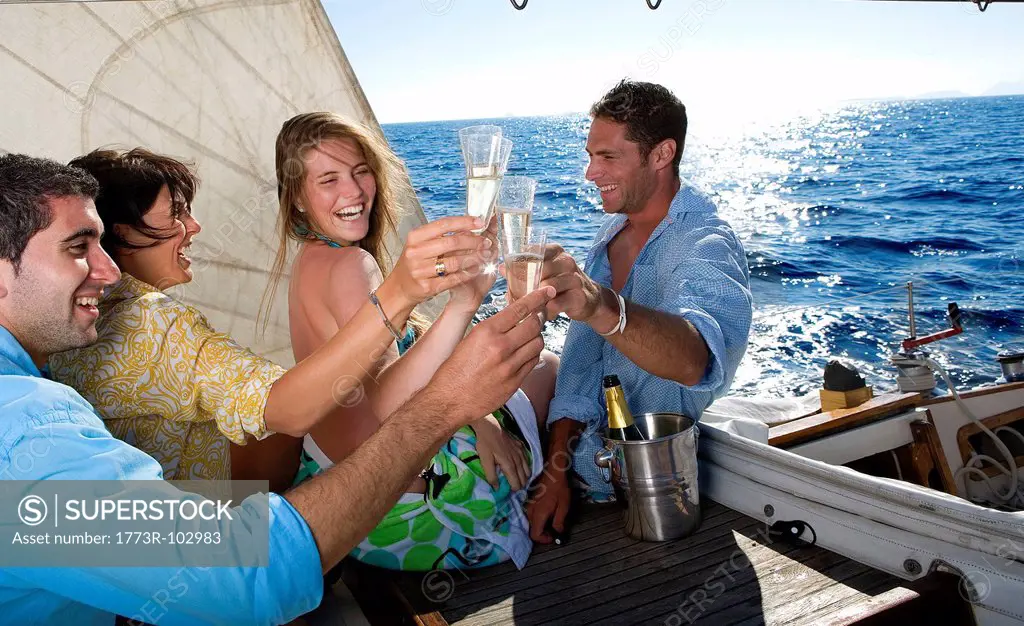 Two couples making a toast on sailboat