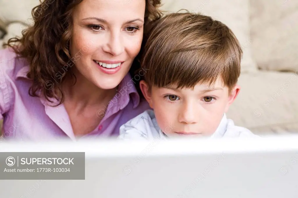 Woman and son staring at laptop
