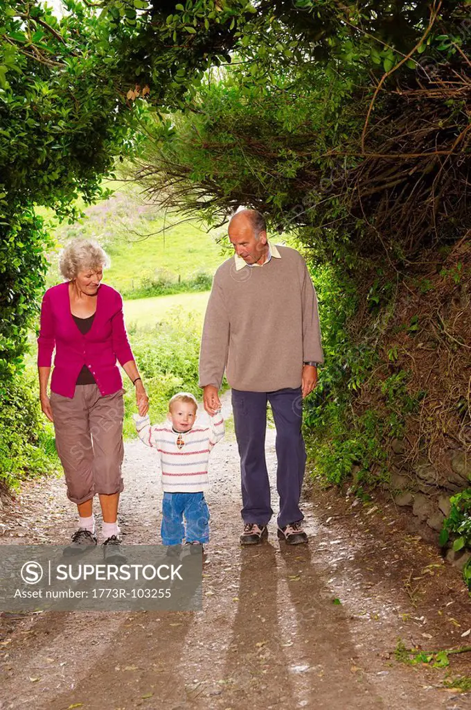 Senior couple walking with child