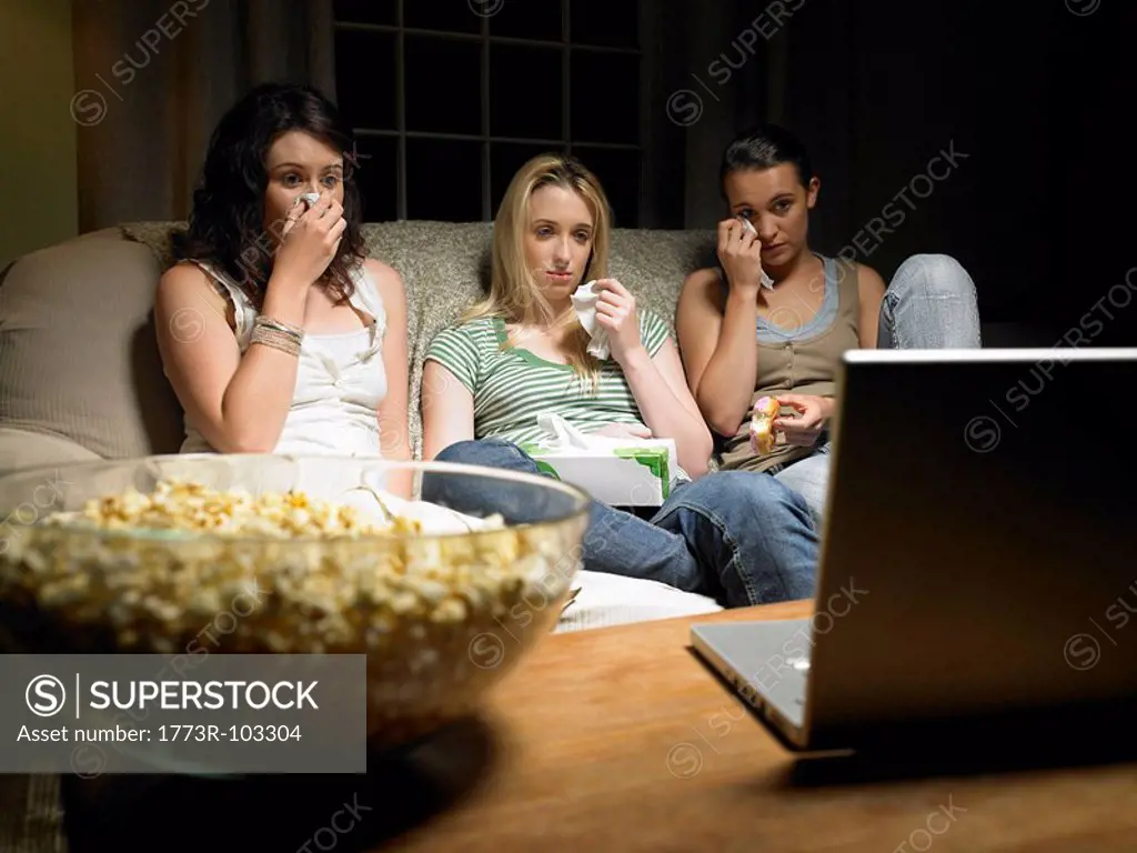 Three young women watching a movie