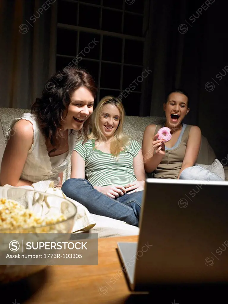 Three young women watching a movie