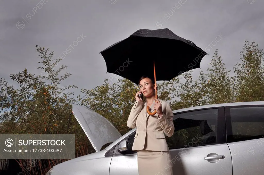 Woman on a phone by her car