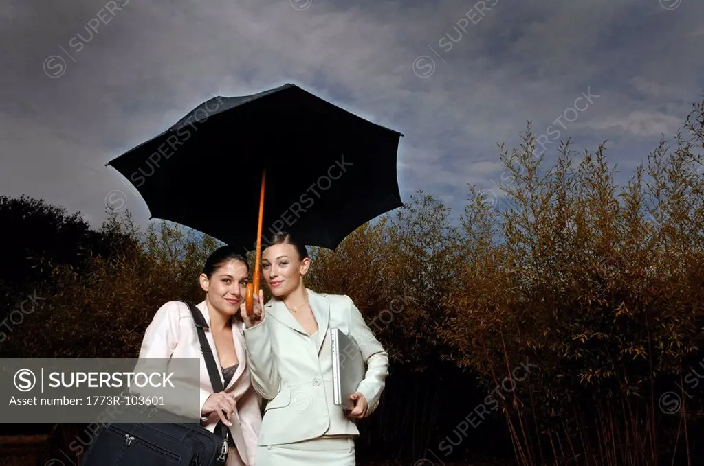 2 women under an umbrella