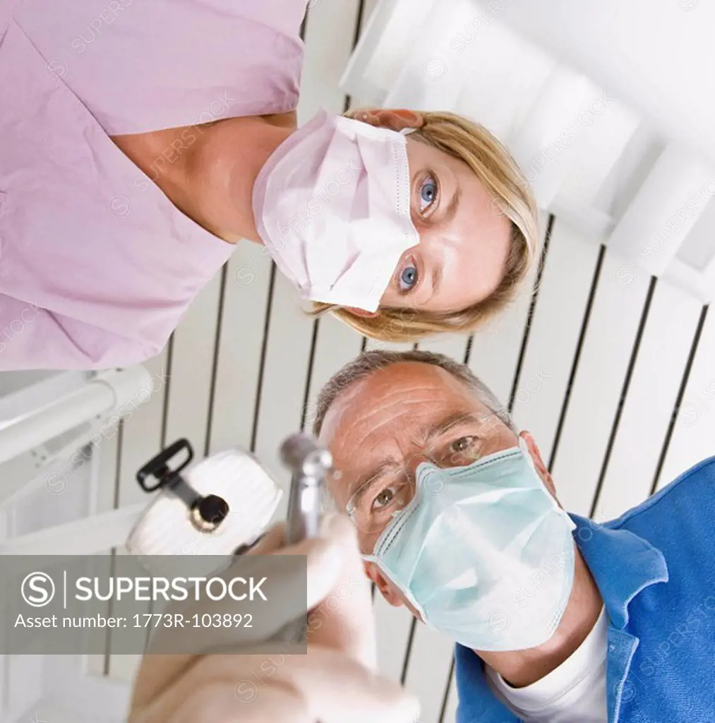Dentist and assistant using tools