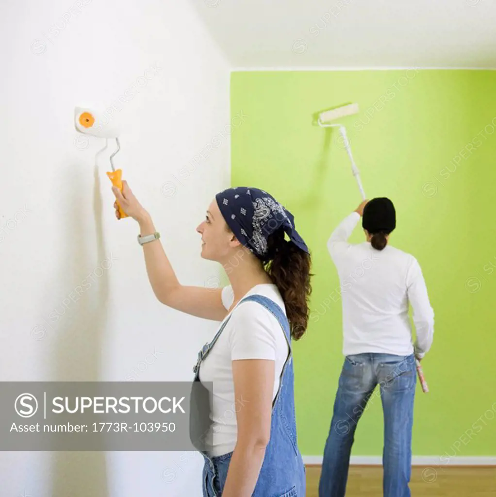 Man and woman painting a room