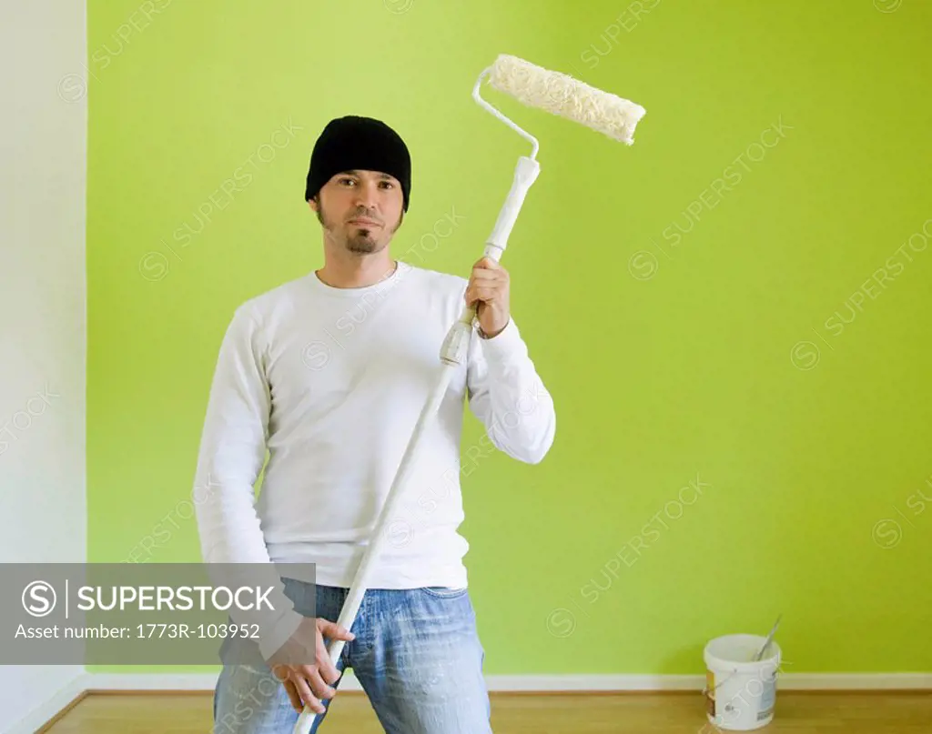 Portrait of a man painting a room
