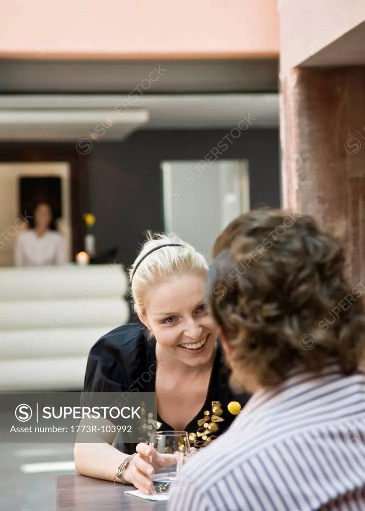 Woman and man talking over drinks