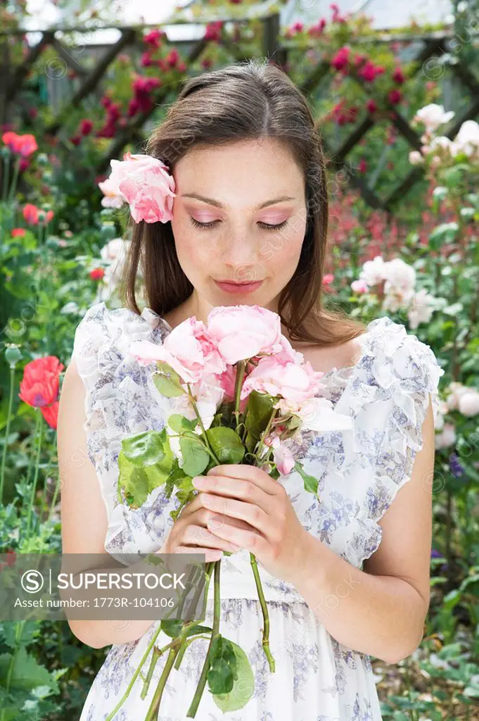Woman holding and smelling roses