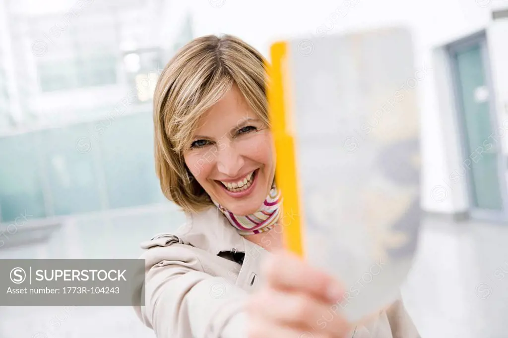 Woman holding ticket smiling