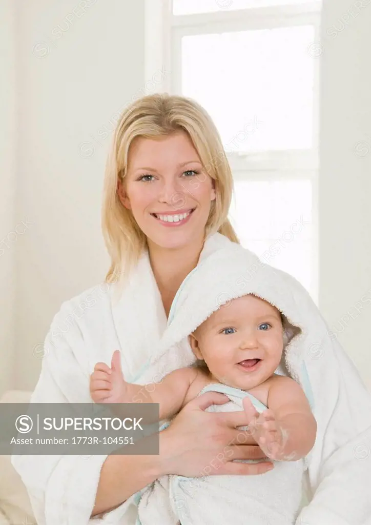 A mother holding her baby in a towel
