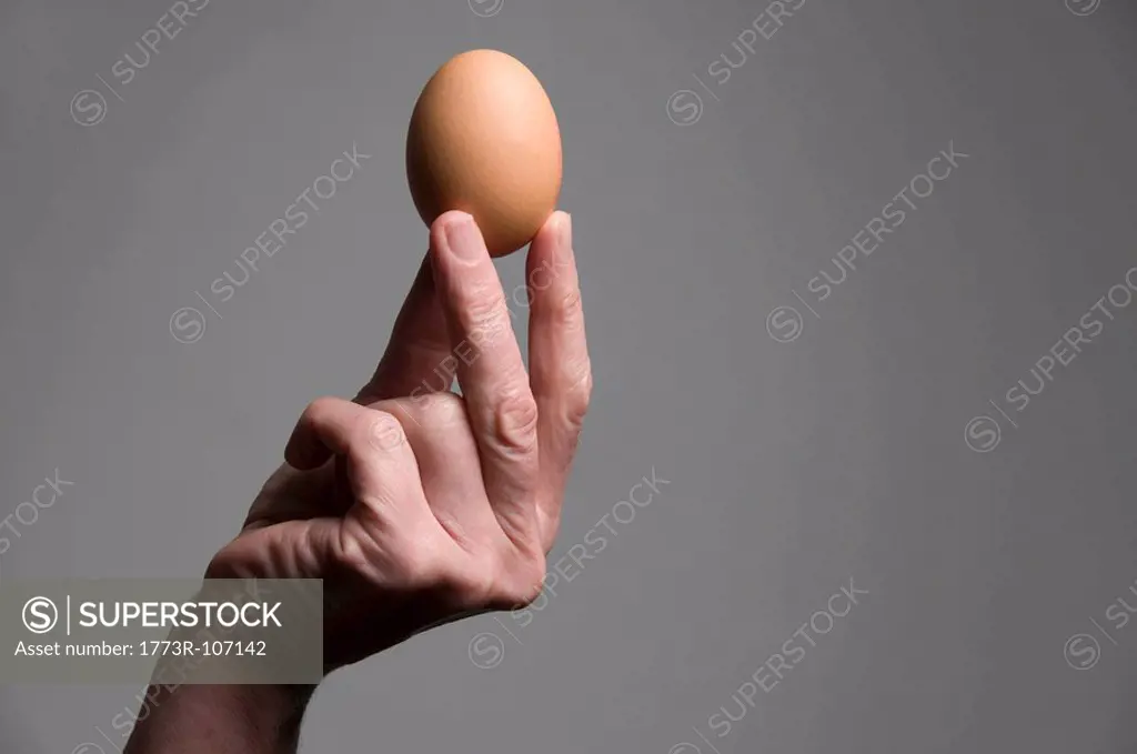 Female hand holding an egg